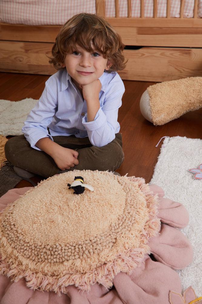 Lorena Canals Pink Daisy floor cushion in a cozy kids room