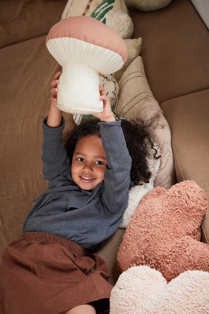 Lorena Canals Boletus mushroom cushion styled in a children’s room