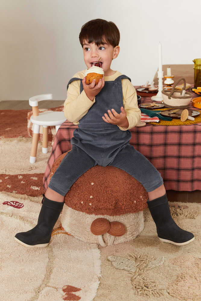 Lorena Canals Boletus mushroom pouf shown in a kids play space
