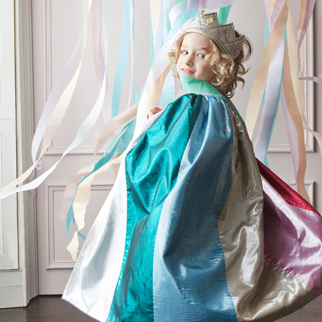 Meri Meri metallic rainbow cape worn by a child
